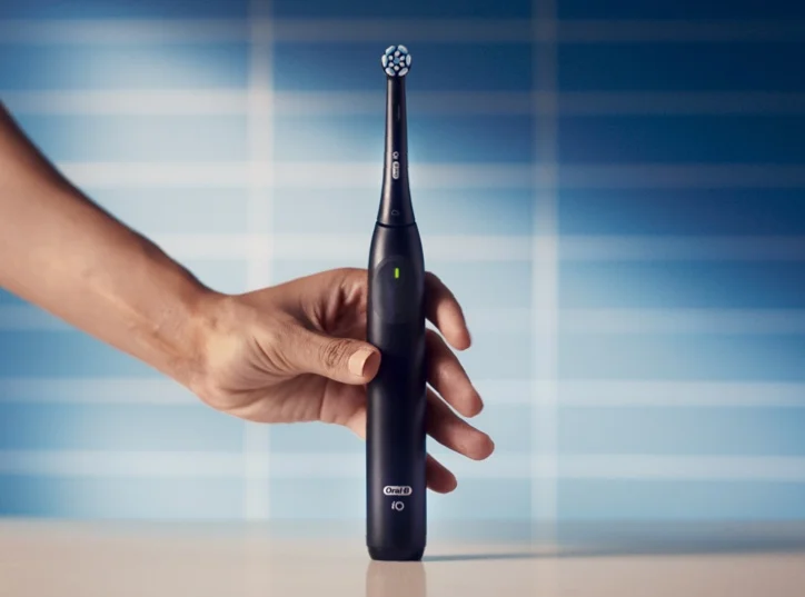 Oral-B iO Electric Toothbrush Black being held by hand model
